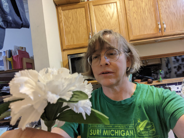 person looking at flower