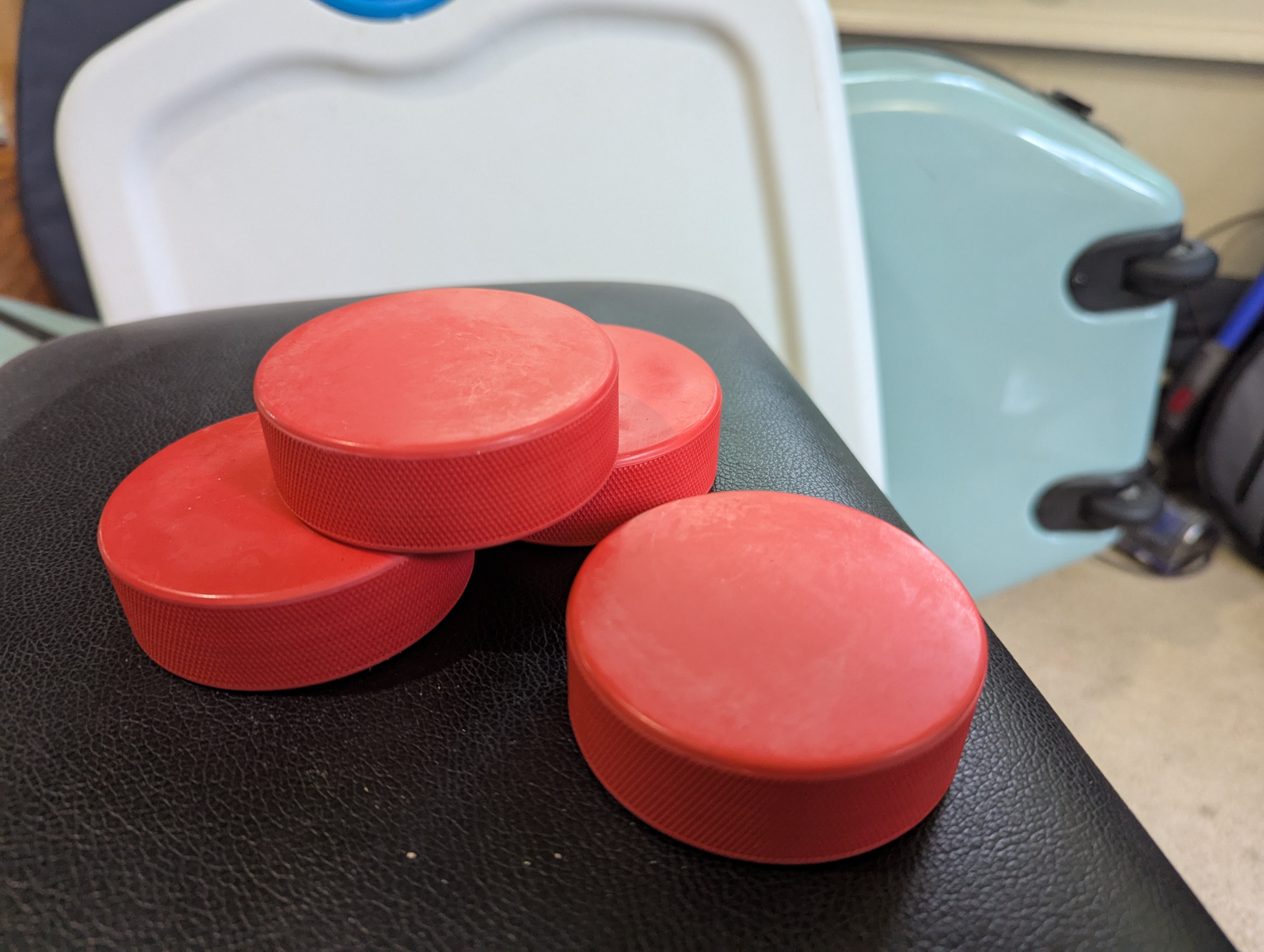 four hockey pucks