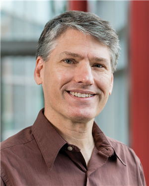 a smiling guy with gray hair