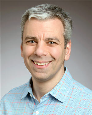 a different smiling guy with gray hair