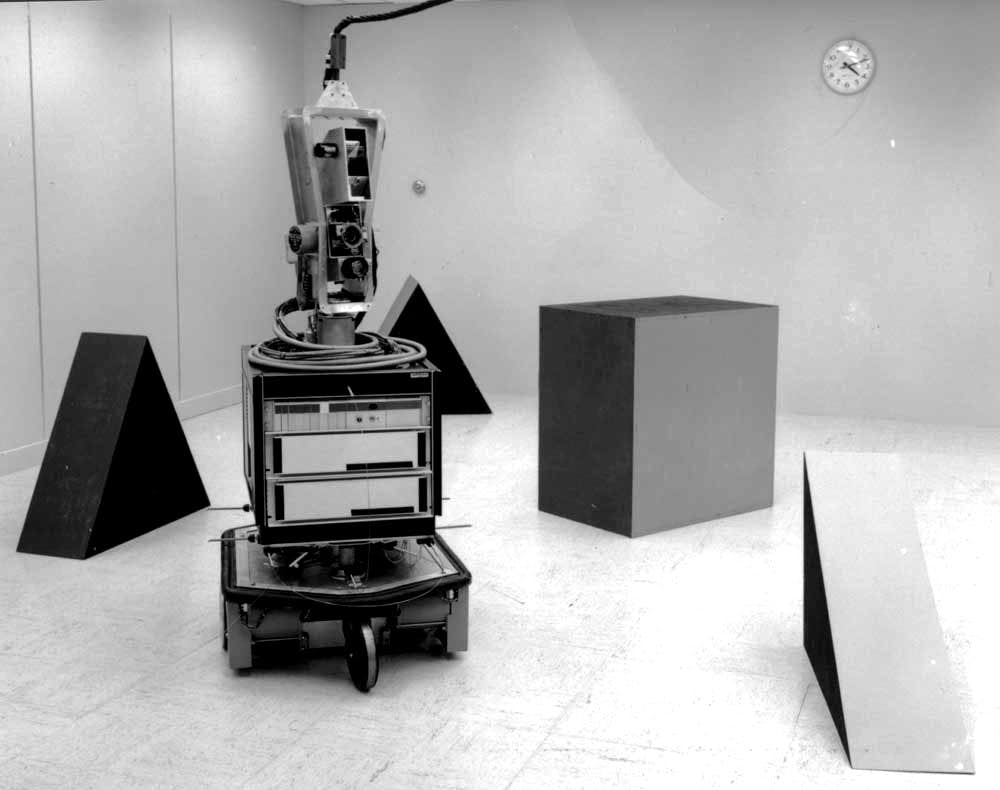 shakey the robot surrounded by three large block-like obstacles