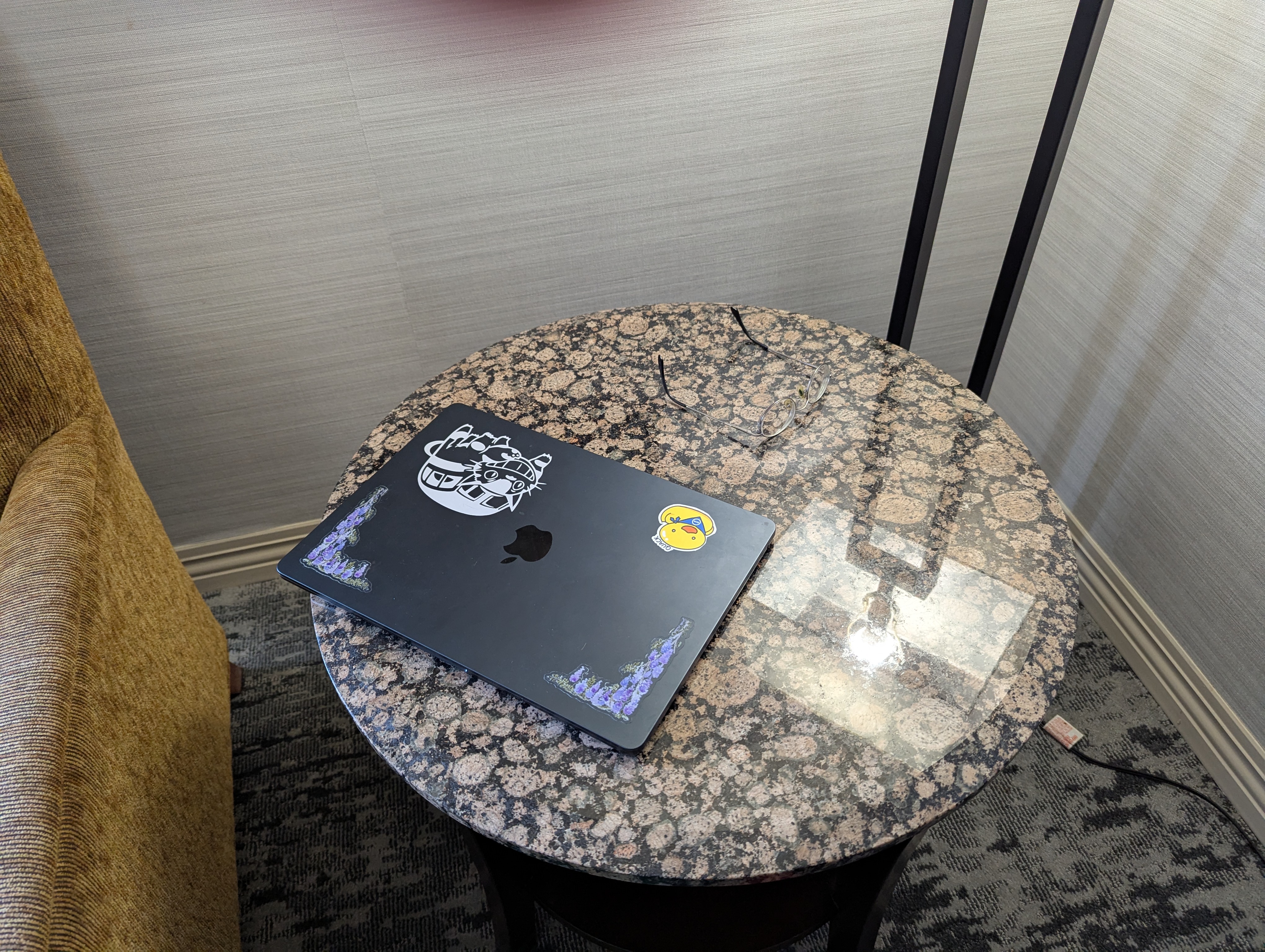 glasses hiding on a textured stone table